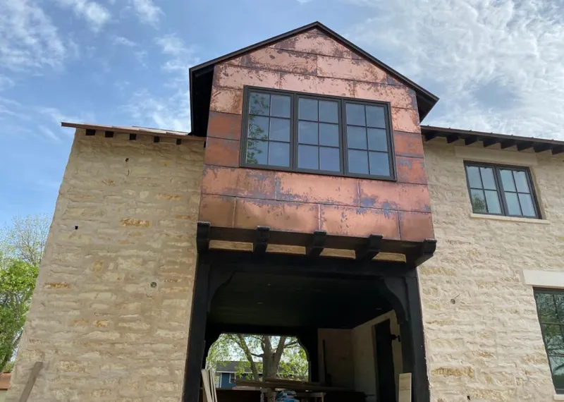 Copper metal panel facade on a stone building for Skylight Installation in Pollock Pines